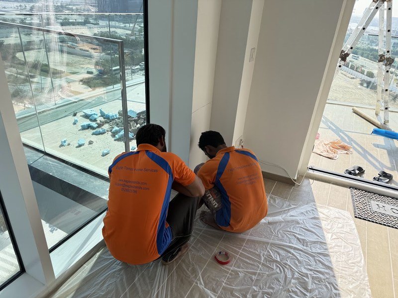 Eagle Trends painting team preparing an interior wall in Abu Dhabi